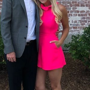 Pink romper with beautiful neckline and bow in the back